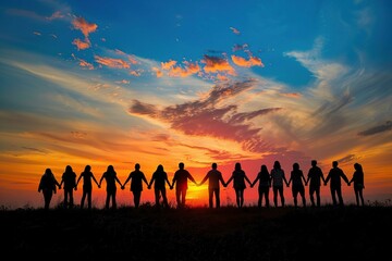 silhouette of a group of people holding hands against a sunset background