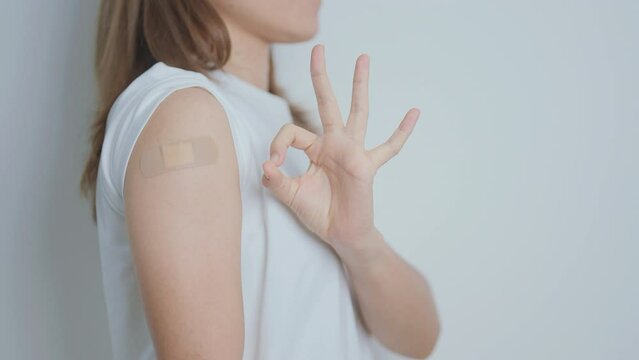 Woman with bandage after receiving vaccine. Vaccination and Immunization for Influenza, HPV, Zoster, IPD, DTP or Diphtheria, Tetanus and Pertussis, MMR, Hepatitis B, Covid  and Varicella vaccine