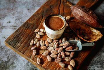 Natural craft cocoa drink, organic healthy chocolate drink with brown cocoa beans and dry cacao pod.Top view,above