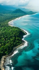 Fototapeta premium A winding coastline from above, showcasing the contrast between lush green jungle, pristine beaches