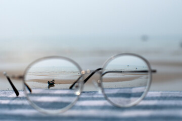 Fototapeta na wymiar Sharp images look good when viewed with glasses, sea view through eyeglasses, selective focus and blurry background, vision concept