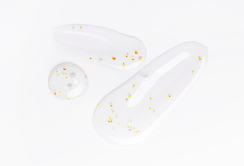 serum gel essence texture with gold closeup on white background