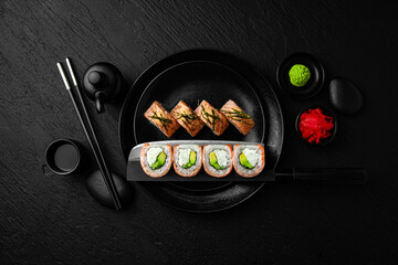 Philadelphia Grill Roll. Sushi composition on black background. The Art of Japanese Cuisine. Food...