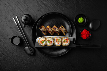 Tempura Roll with salmon. Sushi composition on black background. The Art of Japanese Cuisine. Food...