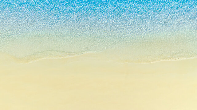 Top view nature of the beach and sea Summer with sunshine, sandy beaches, clear blue waters sparkling against the blue sky. on island with good ecology and environment Background for summer vacation