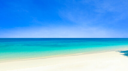 Nature of the beach and sea Summer with sunshine, sandy beaches, clear blue waters sparkling against the blue sky. On an island with good ecology and environment Background for summer vacation concept