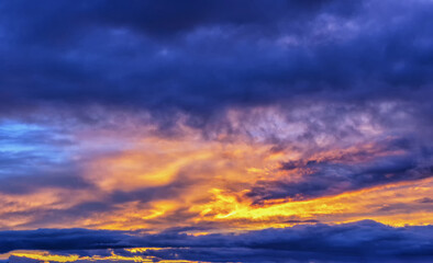 Orange fiery evening sunset sky with clouds