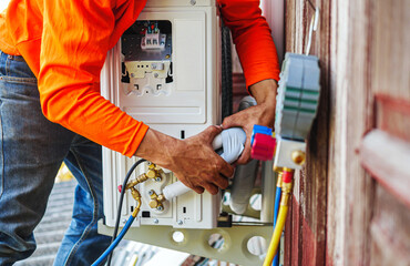 Air conditioning technicians install new compressor air in homes, Repairman fix air conditioning systems, Male technician service for repair and maintenance of air conditioners