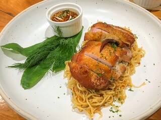 Grilled chicken capellini with Thai Spicy Dipping Sauce is a delicious thai-style pasta menu in Thai restaurant. Pasta menu with Thai herbal chicken roasted.