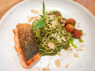 Pesto Spaghetti with grilled salmon in the restaurant.