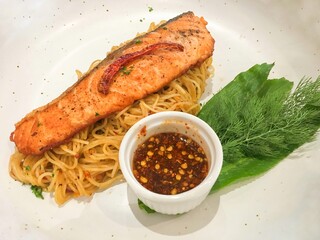 Grilled salmon capellini with Thai Spicy Dipping Sauce is a delicious thai-style pasta menu in Thai restaurant.
