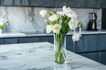 A marble kitchen countertop with spring flowers in a vase on the table