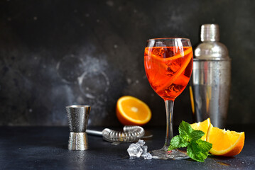 Delicious italian cocktail aperol spritz with orange in a glasses .