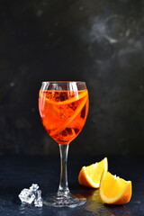 Delicious italian cocktail aperol spritz with orange in a glasses .