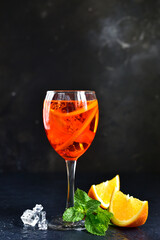 Delicious italian cocktail aperol spritz with orange in a glasses .