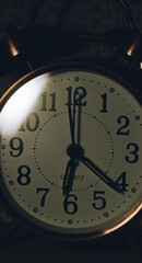 Retro clock with a white dial on a dark background