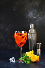 Delicious italian cocktail aperol spritz with orange in a glasses .