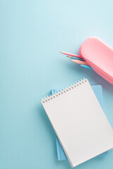 A vertical minimalist back to school setting with a stack of pastel notebooks and a pink pencil...
