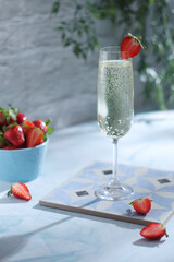 A glass of champagne with strawberries in summer style	