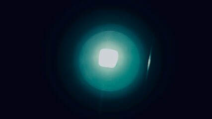 Reflection of a bright light forming into multiple layers from high to low brightness