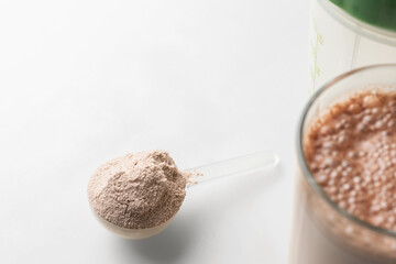 Whey protein powder in measuring scoop