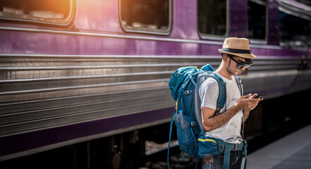 Traveler waits train at train station for travel in summer