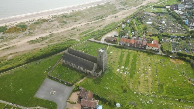 Aerial pan shot of Pakefield Beach Church in Lowestoft, United Kingdom.