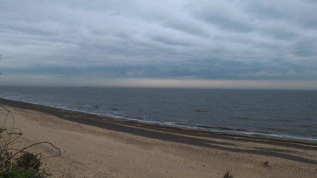 Timelapse shot of Kessingland Beach under a cloudy day in Suffolk, England.