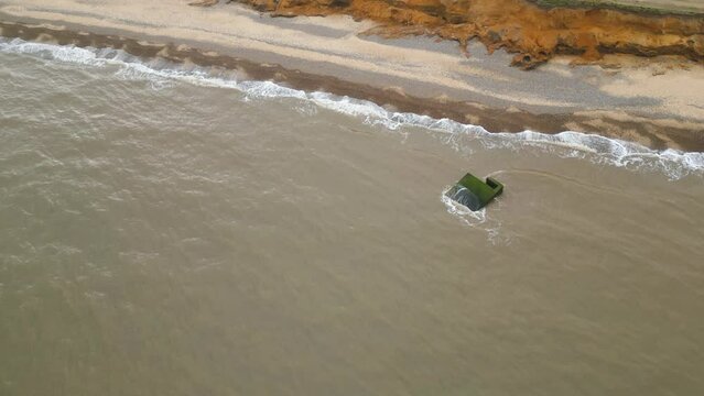 Aerial view of continuous waves hitting the shore of Kessingland Beach in Suffolk, England.