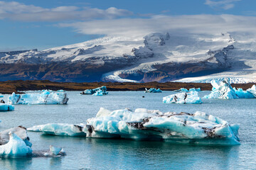 A large body of water with many icebergs floating on it