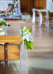 Close up shot of the pews at the Roman catholic church decorated with flowers. Rituals