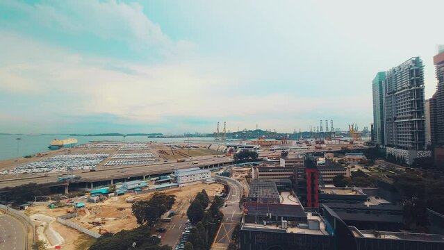 Singapore city, Singapore - 16th march, 2024: zoom in timelapse MCE highway and cars driving by Tanjong Pagar port freight terminal. Shipping, imports exports concept asia