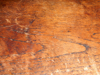 
The surface of the teak wood tiles, which appear worn due to age, creates a distinctive abstract texture with the reflection of the light above.