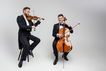 Guys musicians playing contrabass and violin