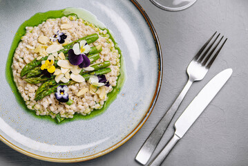 Gourmet risotto with edible flowers on elegant table setting