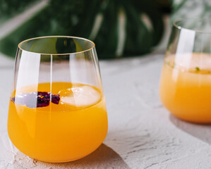 Fresh orange juice in elegant stemless glasses
