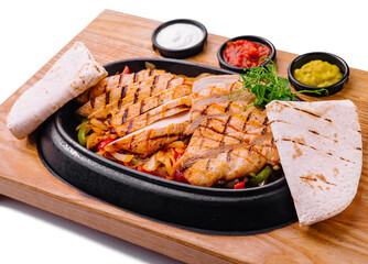 Sizzling chicken fajitas platter with condiments