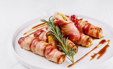 Bacon-wrapped stuffed jalapenos on plate