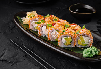 Gourmet sushi rolls on elegant dark plate