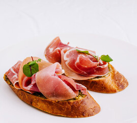 Elegant prosciutto bruschetta on white plate