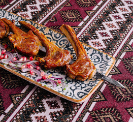 Spicy grilled lamb chops on ornate plate
