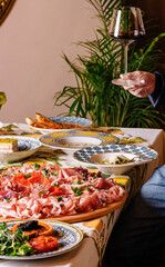 Elegant man holding a salad bowl at a banquet
