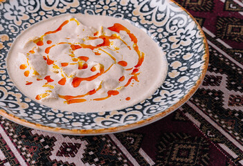 Creamy hummus plate with paprika drizzle