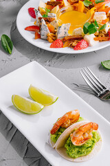 Gourmet salad and shrimp appetizer on elegant plates