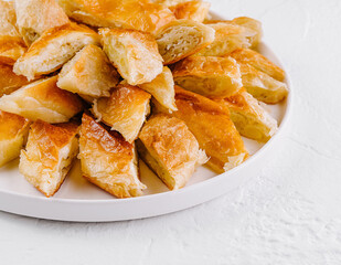 Freshly baked puff pastry bites on plate
