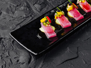 Gourmet tuna sashimi on black slate plate