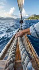 Obraz premium Sailor showing precision hands adjusting sail ropes, olympic sailing sport concept