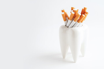 Cigarette with teeth isolated on white background with copy space, No smoking, damage the health of...
