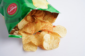 Bangkok, Thailand - May 15, 2022 Potato chips in open bag, delicious BBQ seasoning spicy for crips,...