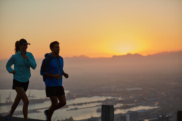 Fototapeta premium Sunrise, couple and silhouette with mountain running for training, exercise and fitness with cardio. Wellness, sport and athlete with runner partner in nature together at morning with mockup space